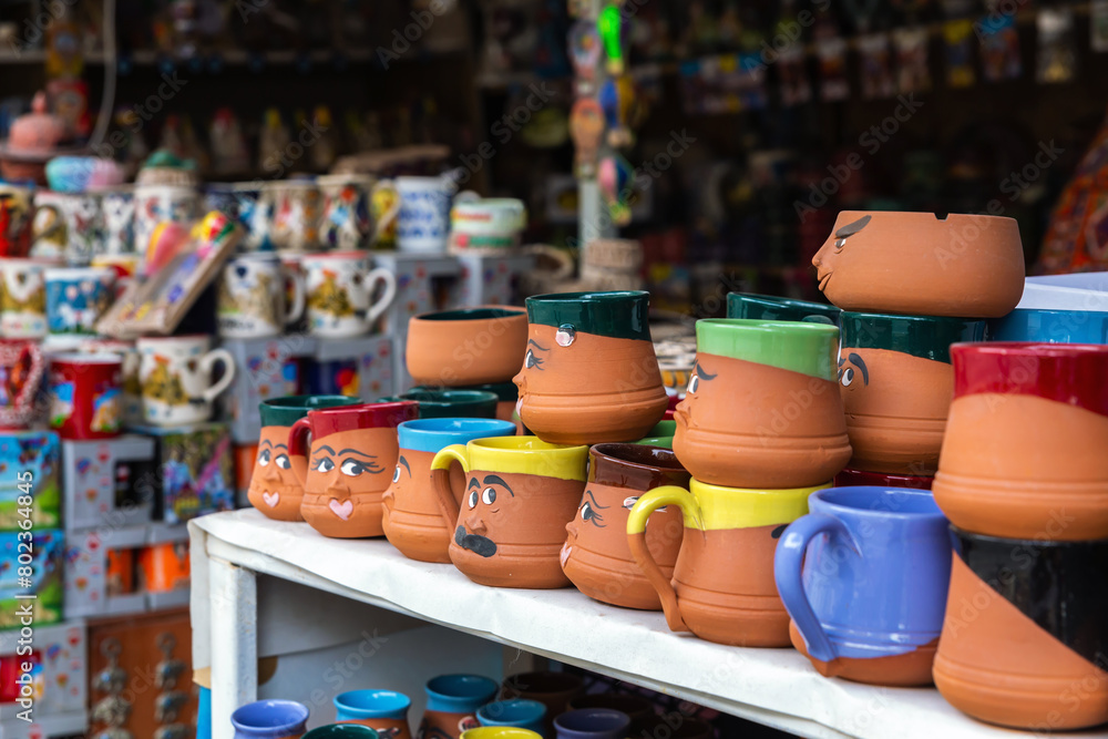 Playful character mugs on display at a souvenir shop in Cappadocia, showcasing vibrant colors and fun designs, perfect for retail and travel-related content.  Goreme, Cappadocia, Turkey