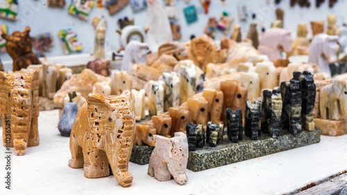 Display of carved stone animal figurines at a Turkish market, showcasing diverse textures and natural tones, ideal for cultural and decorative themes.  Goreme, Turkey photo