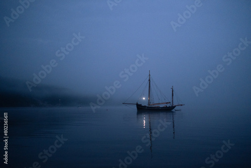 Sailboat at sea during a foggy night