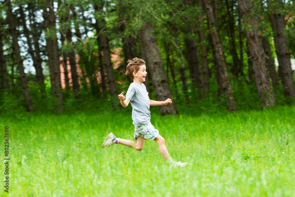 Boy running trough the grass field Boy running trough the grass field