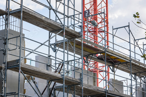 Detailed shot of a scaffolding with a crane in the background