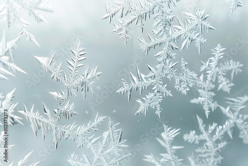 A minimalist background featuring a delicate frost pattern on a clear glass surface, simulating winter's touch.