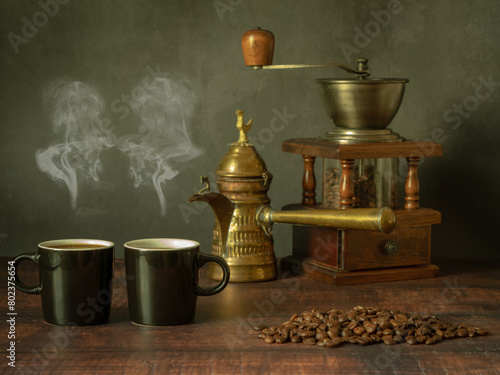 Vintage stylized still life with cups of aromatic coffee and coffee beans on a wooden table.