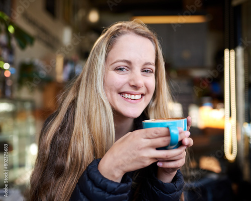 Portrait  laughing or happy woman with coffee in cafe to relax  chill and enjoy warm beverage in Germany. Cappuccino latte  smile or face of girl on break with tea  caffeine or hot chocolate in diner