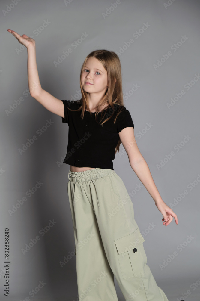 A girl extends her arm gracefully, poised and playful. Captures the innocence and dreams of youth, a dance of aspirations. A girl extends her arm gracefully, poised and playful. Captures the innocence and dreams of youth, a dance of aspirations.