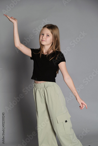 A girl extends her arm gracefully, poised and playful. Captures the innocence and dreams of youth, a dance of aspirations.