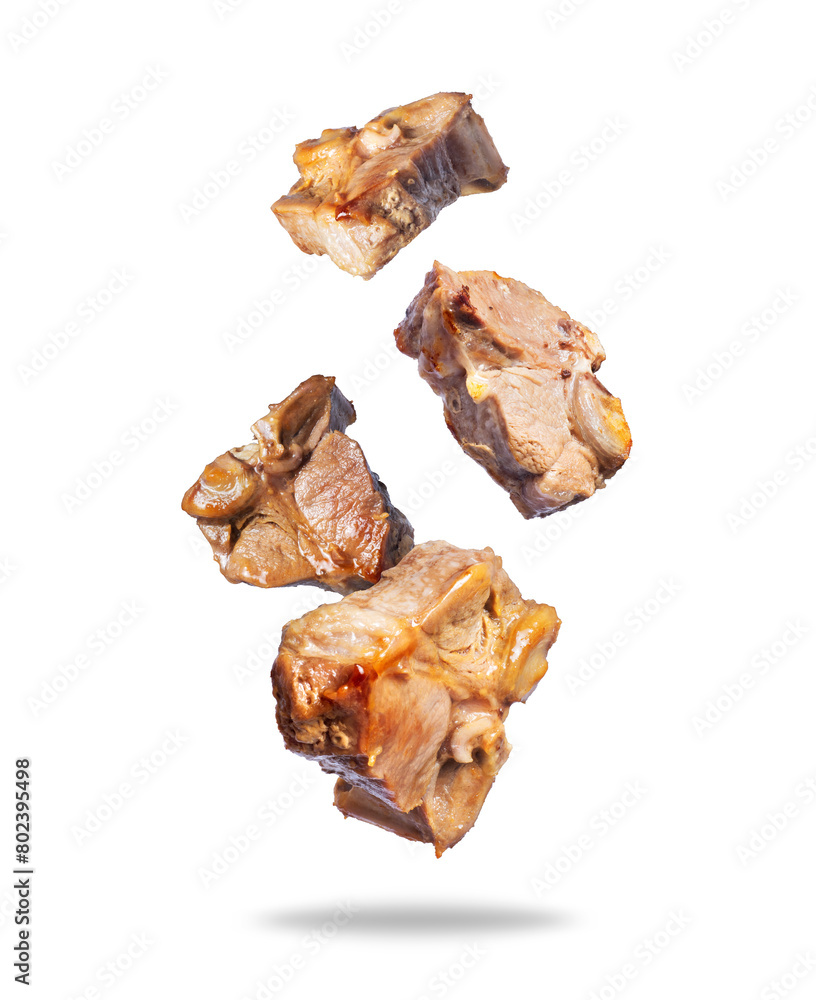 Fried beef steaks close up in the air isolated on a white background Fried beef steaks close up in the air isolated on a white background