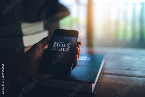 hand holding smart phone for read bible app. ready to study the Bible in the teachings of God.