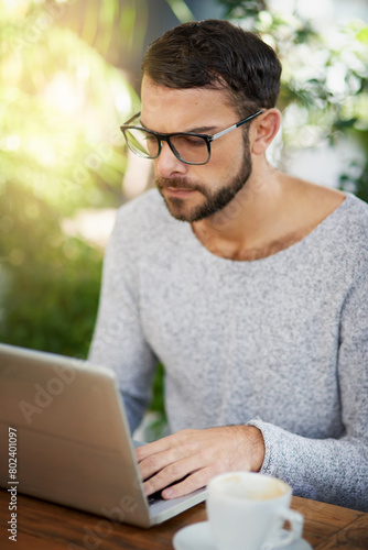 Business, man and laptop in cafe for remote work, email, and research for writing. Confident, male person and copywriter with computer for freelance articles and blog indoors at coffee shop.