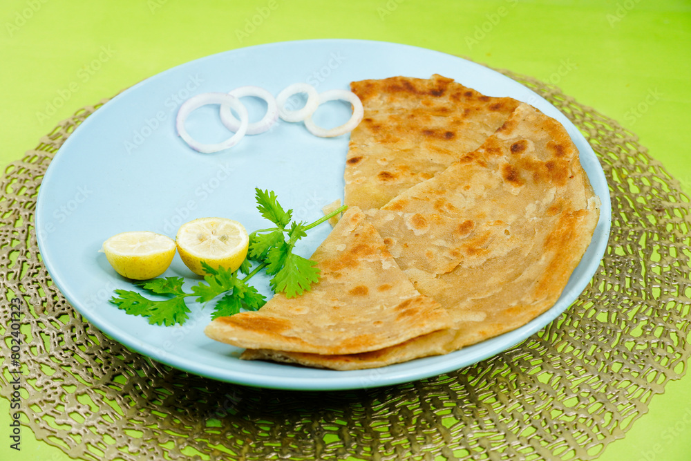 Paratha in colourful plate. Paratha on white background. Indian, Pakistani favourite Paratha. Paratha in colourful plate. Paratha on white background. Indian, Pakistani favourite Paratha.