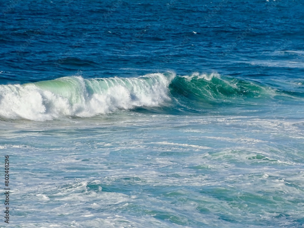 Stunning View of Emerald Waves Rolling onto Shore, a Mesmerizing Portrait of the Ocean's Ever-Changing Moods