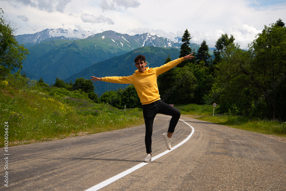 A young attractive student is resting in the mountains. A young attractive student is resting in the mountains.