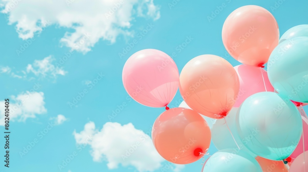 A cluster of vibrant balloons gently floating in the sky A cluster of vibrant balloons gently floating in the sky