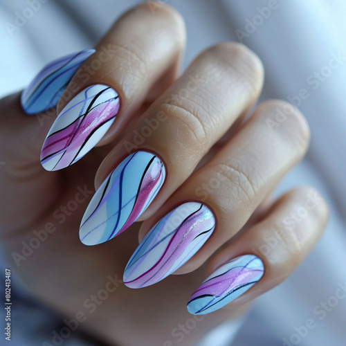 A woman's hand with purple and white nail polish