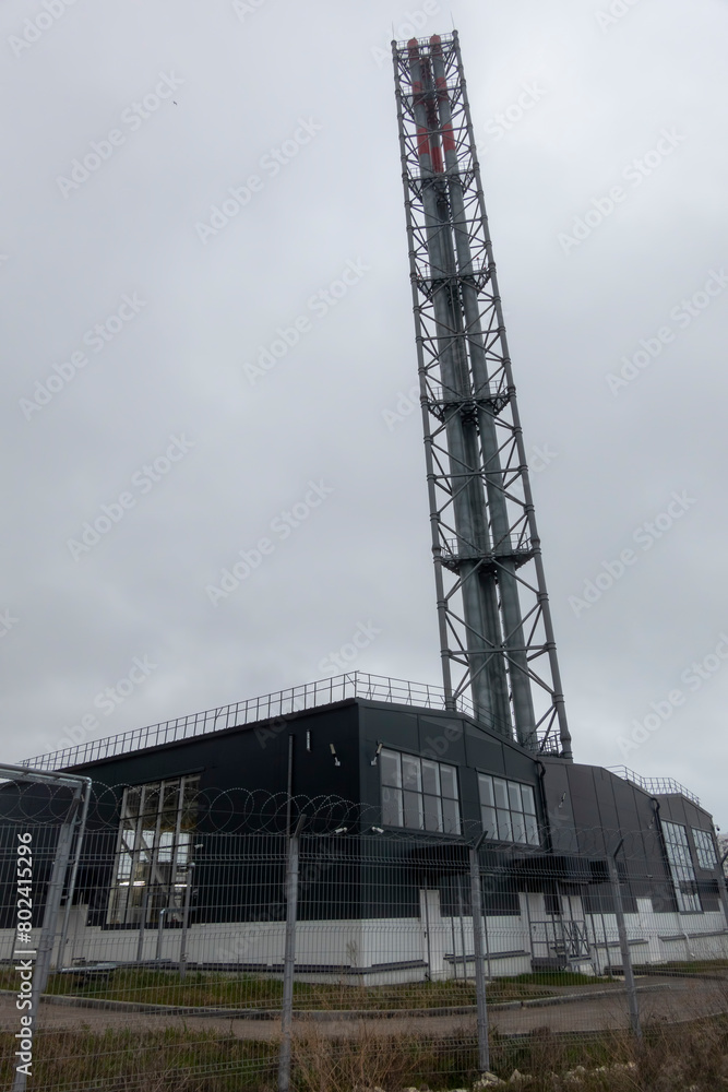 High pipe and a thermal power plant heating in the city urbanism
