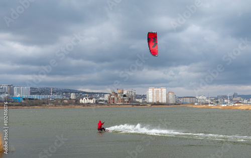 A kite surfer rides and jumps the waves the black sea