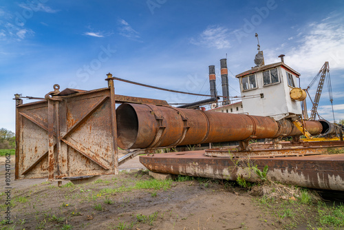 detail of old, rusty, river dredge on a shore of Missouri River in Nebraska