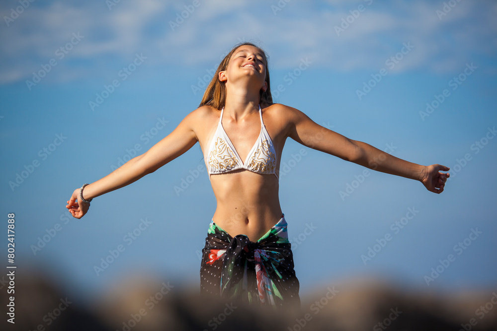 Happy teenage girl on the sunny beach smiling and engoying Happy teenage girl on the sunny beach smiling and engoying