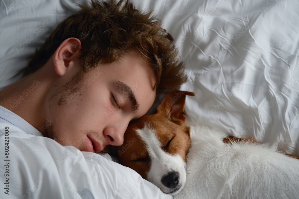 Young man sleeping with his dog Young man sleeping with his dog