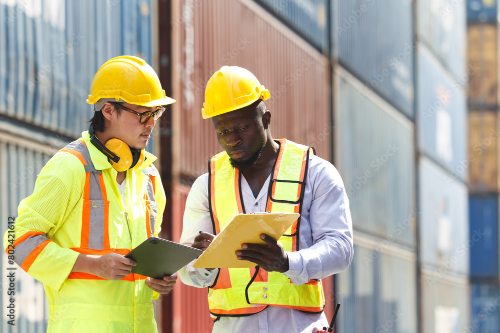 Container yard workers examine the container cargo. Container yard workers examine the container cargo.