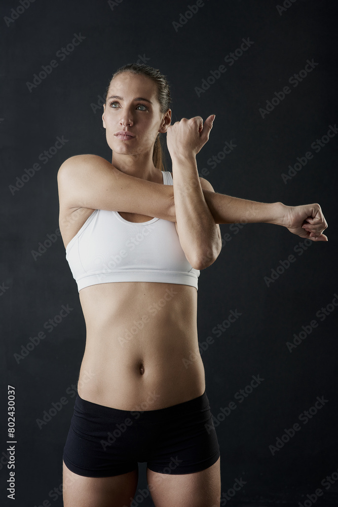 Stretch, woman and arms for fitness in studio for health training or workout as athlete runner for marathon competition. Active, female person and sports for strong muscle or achievement of goal Stretch, woman and arms for fitness in studio for health training or workout as athlete runner for marathon competition. Active, female person and sports for strong muscle or achievement of goal