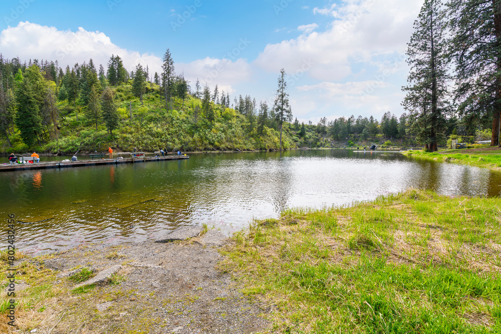 A narrow bay alongside the public park and boat launch at the 423 acre Fernan Lake, a natural lake in the downtown residential area of Coeur d'Alene, Idaho, in the North Idaho Panhandle region.