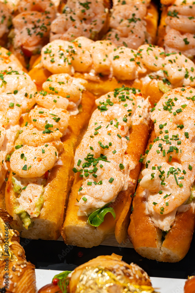 Fresh baked brioche buns filled with crab meat and shrimps ready to eat in food hall, London, Covent Garden market Fresh baked brioche buns filled with crab meat and shrimps ready to eat in food hall, London, Covent Garden market