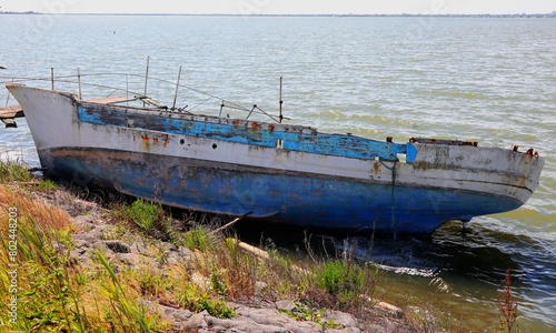 Broken boat shipwreck washed ashore after sea crossing