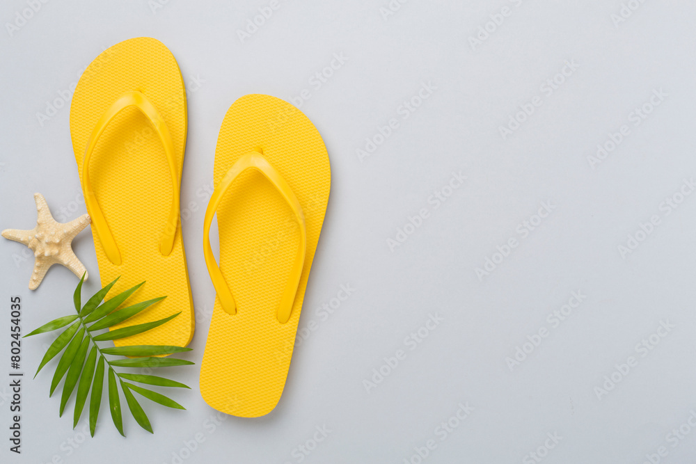 Bright yellow flip-flops on color background, top view. Summer concept Bright yellow flip-flops on color background, top view. Summer concept