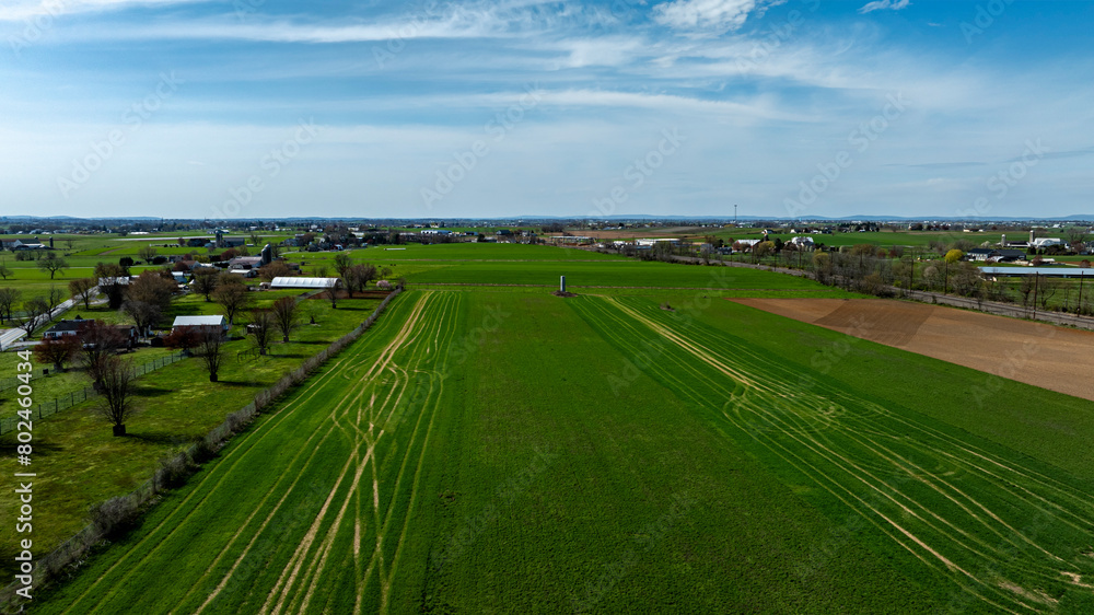 An Aerial View Of A Lush, Vibrant Farm Landscape With Distinct Green Fields.
