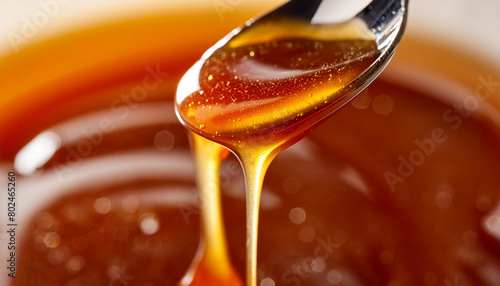 An image of a spoon with caramel dripping from it. Image of sweet melted sugar. AI Generated