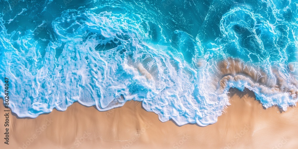 Ocean waves on the beach. Beautiful natural summer vacation holidays background. Aerial top down view of beach and sea with blue water waves Ocean waves on the beach. Beautiful natural summer vacation holidays background. Aerial top down view of beach and sea with blue water waves