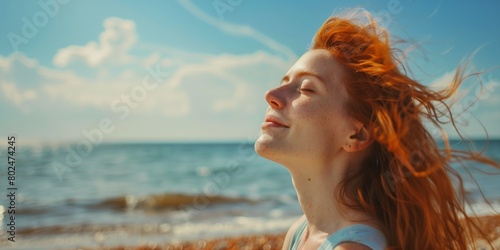 Red-haired woman on the seashore in summer
