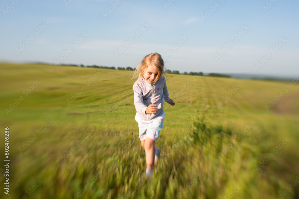 girl runs across the field, kid, childhood, yellow field, blonde girl runs across the field, kid, childhood, yellow field, blonde