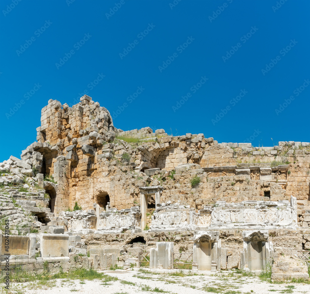Picturesque ruins of an amphitheater in the ancient city of Perge, Turkey. Perge open-air museum.