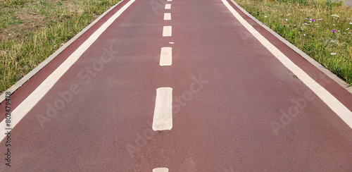 Wallpaper Mural A red synthetic treadmill or bike path with white markings Torontodigital.ca