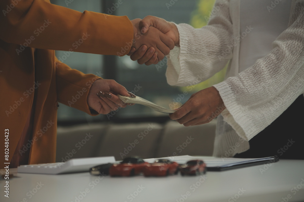 Insurance officers hand over the car keys after the tenant. have signed an auto insurance document or a lease or agreement document Buying or selling a new or used car with a car Insurance officers hand over the car keys after the tenant. have signed an auto insurance document or a lease or agreement document Buying or selling a new or used car with a car