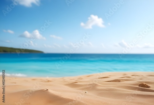 Sandy beach with turquoise ocean and blue sky in the background