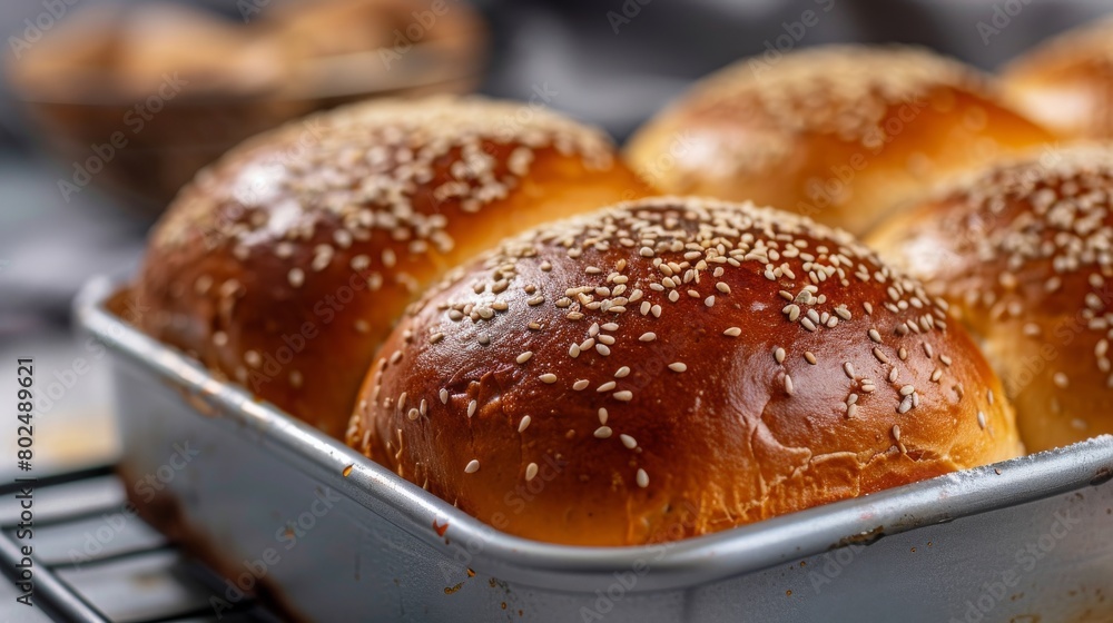 Close up shot homemade food baking concept. Fresh hot soft fluffy ginger golden brown sesame seeds buns pie bread dessert pastry in loaf pan. Bakery products, image with copy space.