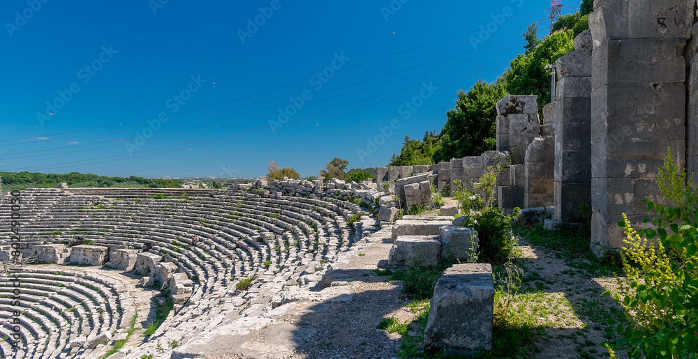 Fototapeta premium Picturesque ruins of an amphitheater in the ancient city of Perge, Turkey. Perge open-air museum.