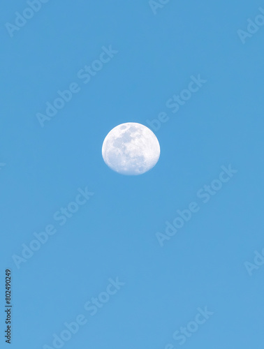 Moon Early in the Evening Blue Sky with Details of Its Craters 