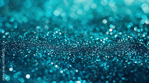 Abstract close-up of twinkling blue glitter with a shallow depth of field for a magical background texture. 
