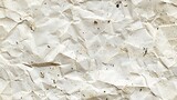 A close-up image of crumpled paper with creases and speckles on a white background, perfect for a texture overlay or a creative background design. 
