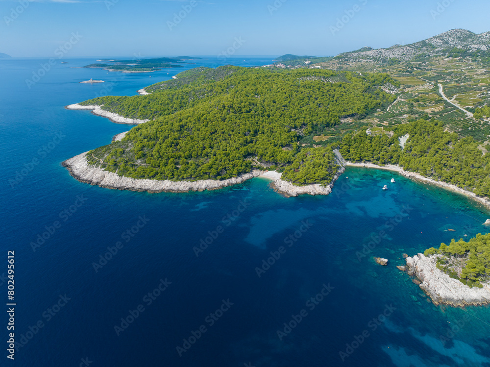 AERIAL: Flying towards a rugged rocky seafront of the Adriatic island of Hvar