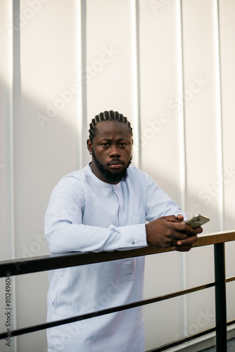 Portrait of a happy african american man wearing ethnic dashiki clothes outdoor in summer street wall. Millennial generation student and youth. Copy space