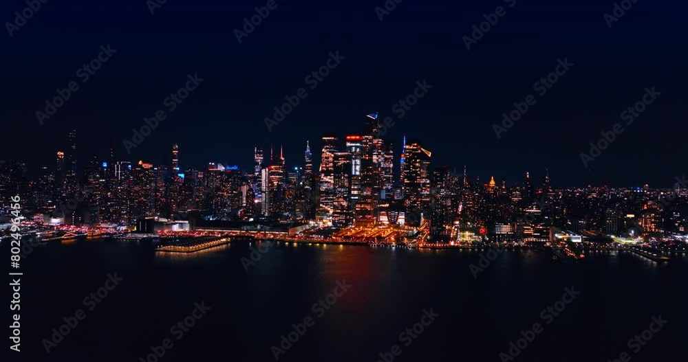 Dazzling skyline of modern New York at night. Approaching the waterfront of metropolis over the East River. Dazzling skyline of modern New York at night. Approaching the waterfront of metropolis over the East River.