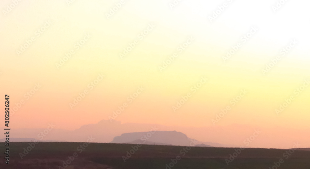Mountains progressively getting larger in the distance on a foggy, pastel morning near Mooi River, South Africa