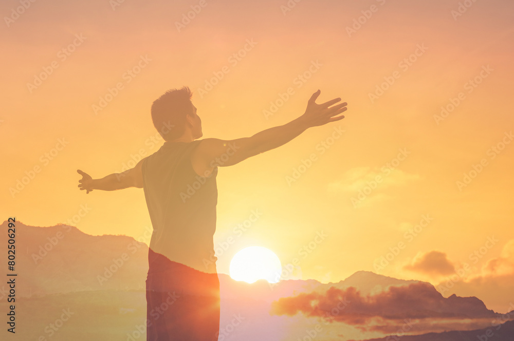 Happy man feeling free on the sunset in nature in summer with open arms. Freedom and carefree enjoyment people  enjoying life, success, health, hope and faith concept