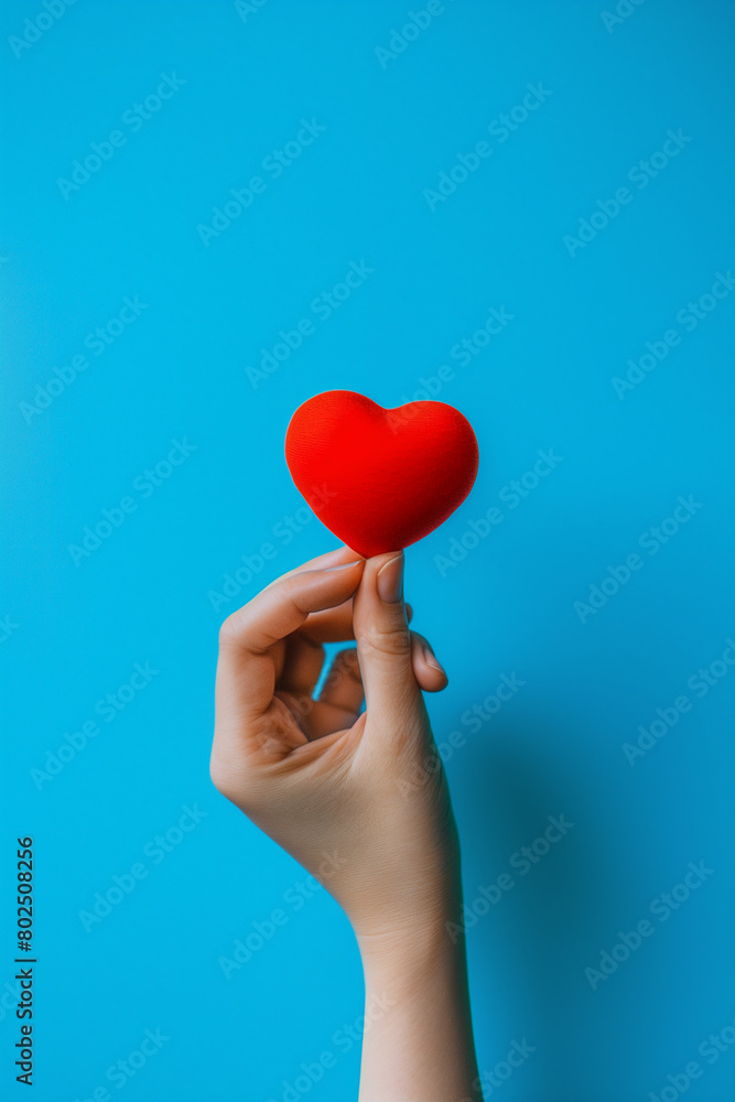Woman's Hand Holding Red Heart on Blue Background (generative AI) Woman's Hand Holding Red Heart on Blue Background (generative AI)