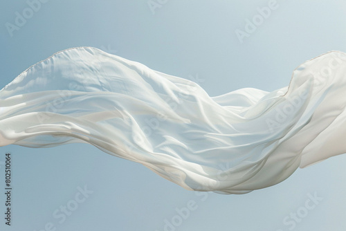 A plain white scarf floating in the wind. photo